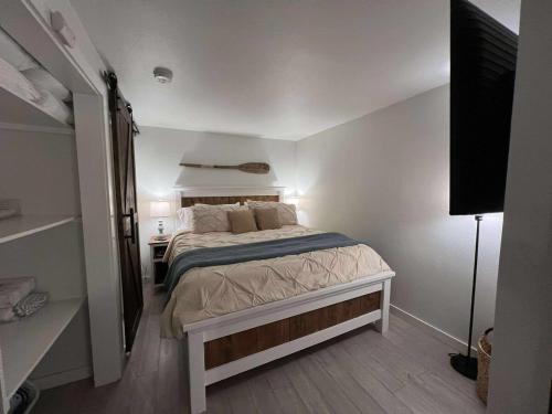 a bedroom with a bed and a desk and a television at Powder and Paddle in McCall