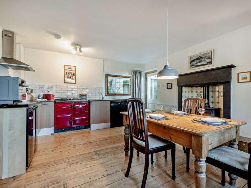 a large kitchen with a wooden table and chairs at 2 Bed in Lochranza 77882 in Lochranza
