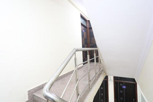 a staircase in a building with a metal railing at Hotel O A P Residency in Noida