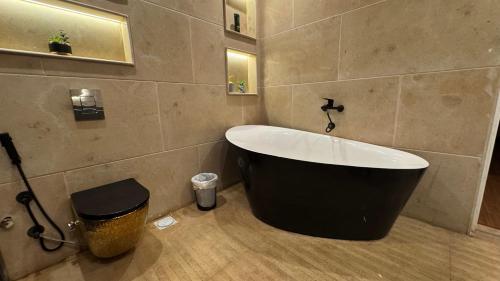 a bathroom with a bath tub and a trash can at RAFiF Pyramids View Hotel in Cairo