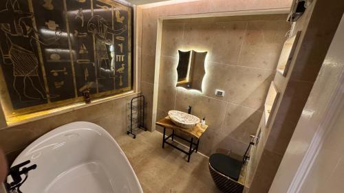 a bathroom with a urinal and a sink at RAFiF Pyramids View Hotel in Cairo