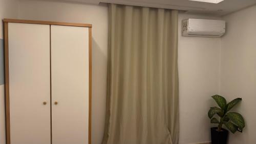 a bedroom with a white closet and a curtain at RAFiF Pyramids View Hotel in Cairo
