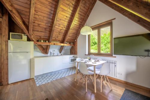 a kitchen with a white table and chairs at Las casita de mache - CASISI in Cerler