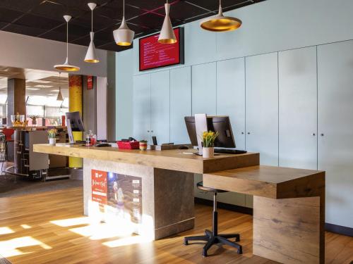 an office with a desk with a computer on it at ibis Paris Creteil in Créteil