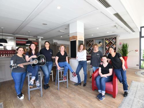 a group of people posing for a picture in a room at Ibis Nantes la Beaujoire Parc Expo in Nantes