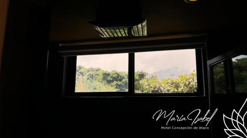 a window with a basket on top of it at Hotel María Isabel Ataco in Concepción de Ataco