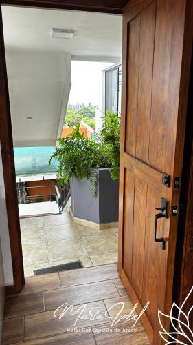 an open door to a room with potted plants at Hotel María Isabel Ataco in Concepción de Ataco