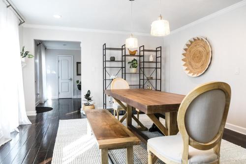 a dining room with a wooden table and chairs at Cozy Home with POOL plus CHEFS kitchen in Prime Area in Charlotte