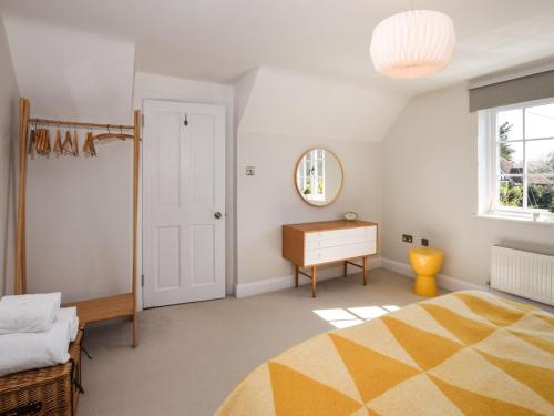 a bedroom with a bed and a dresser and a mirror at 3 Bed in Tenterden 83843 in Saint Michaels