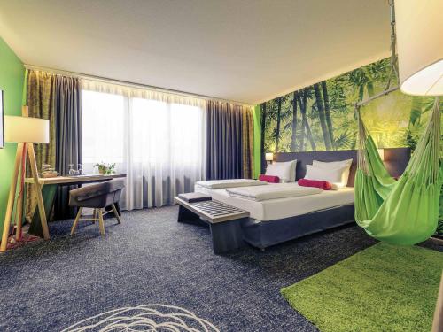 a hotel room with a bed and a hammock at Mercure München City Center in Munich