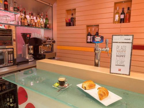 a bakery with a table with a plate of croissants at ibis Limoges Centre in Limoges