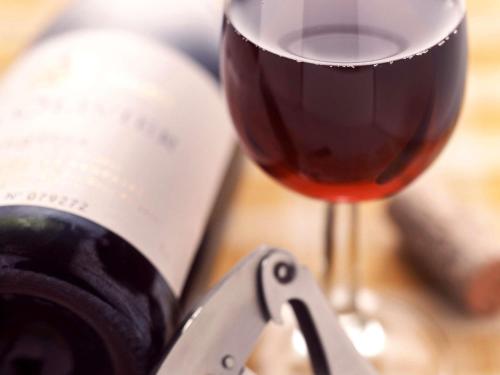 a glass of red wine next to a wine opener at Ibis Avranches Baie du Mont-Saint-Michel in Saint-Quentin-sur-le-Homme
