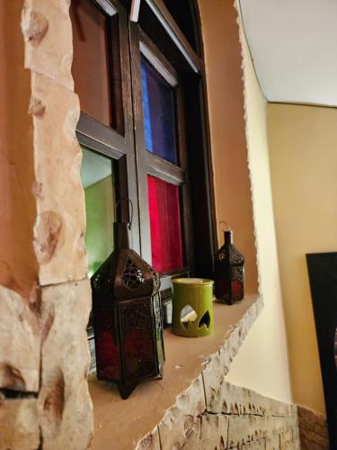 a window with some items on a stone ledge at Riad Hostel ADI in Marrakech
