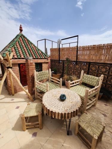 a patio with a table and chairs and a building at Riad Hostel ADI in Marrakech