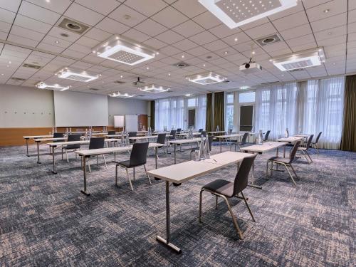 a large room with tables and chairs in it at Novotel Zürich Airport Messe - newly renovated in Glattbrugg