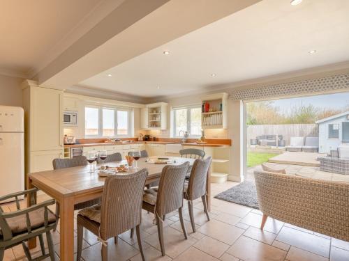 a kitchen and dining room with a table and chairs at 4 Bed in West Runton 81469 in West Runton