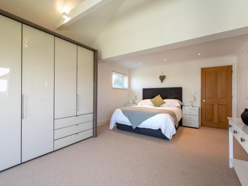 a bedroom with a large bed and a dresser at 4 Bed in West Runton 81469 in West Runton