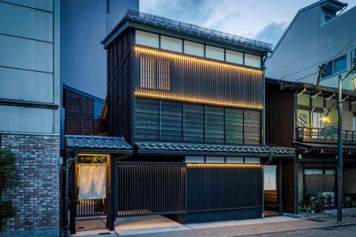 a building with lights on the side of it at Asatoyuu Machiya House in Takayama