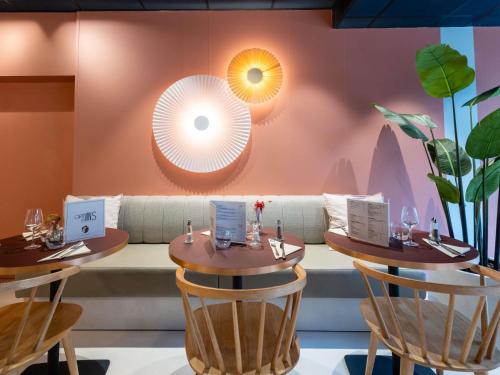 a dining room with two tables and a couch at ibis Lille Centre Gares in Lille