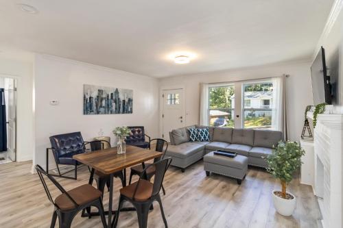 a living room with a couch and a table and chairs at New Home in MidTown- Sleeps 11 For Rent in Atlanta in Atlanta