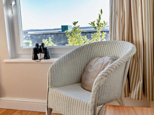 a chair with a pillow in a room with a window at 2 Bed in Haverigg 94052 in Haverigg