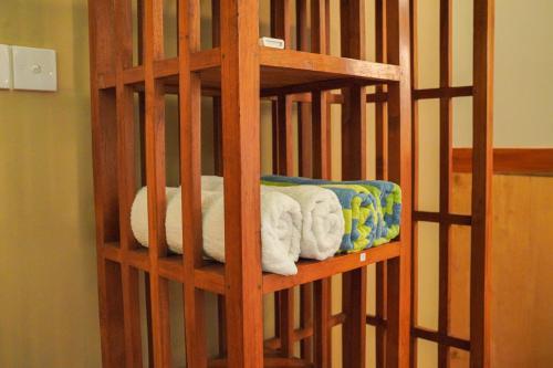 a wooden book shelf filled with lots of towels at Belongas Bay Lodge LOMBOK in Blongas