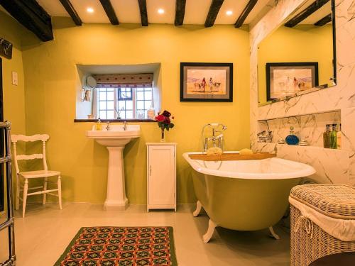 a bathroom with a large tub and a sink at 5 Bed in Betws-y-Coed 55987 in Pentrefoelas