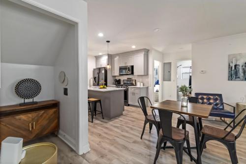 a kitchen and living room with a table and chairs at New Home in MidTown- Sleeps 11 For Rent in Atlanta in Atlanta