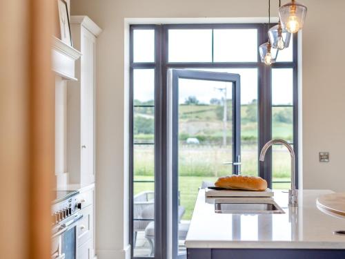 a kitchen with a counter with a sink and a window at 5 Bed in Shrewsbury 80686 in Llanymynech