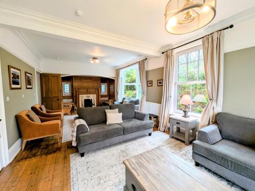 a living room with two couches and a table at 9 Bed in Keswick SZ238 in Keswick
