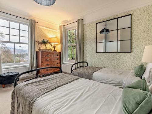 two beds in a room with two windows at 9 Bed in Keswick SZ238 in Keswick