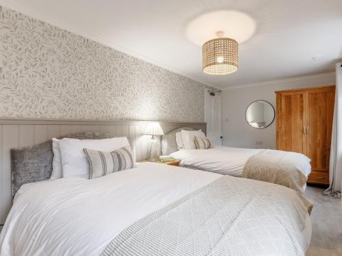 two beds in a bedroom with white walls at 9 Bed in Keswick SZ238 in Keswick