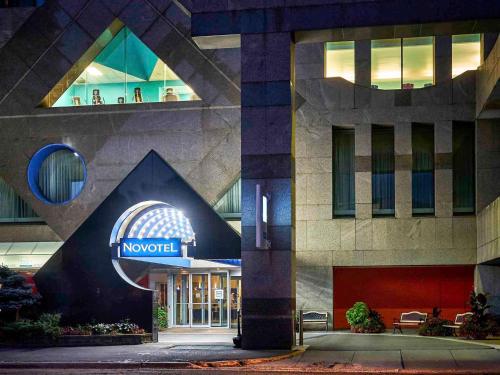 a hotel with a sign on the front of a building at Novotel Toronto North York in Toronto