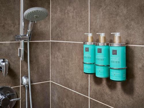 a group of four bottles of water in a shower at Novotel Toronto North York in Toronto