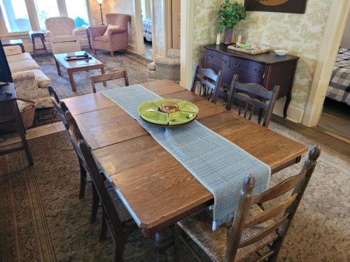 a wooden table with a plate of food on it at Lil's On The Lake Vintage Cottage On Crystal Lake in Beulah