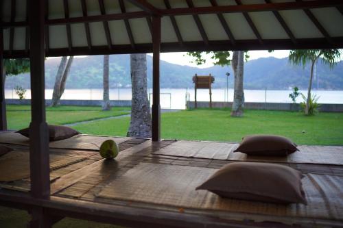 a wooden table with a fruit on top of it at Belongas Bay Lodge LOMBOK in Blongas