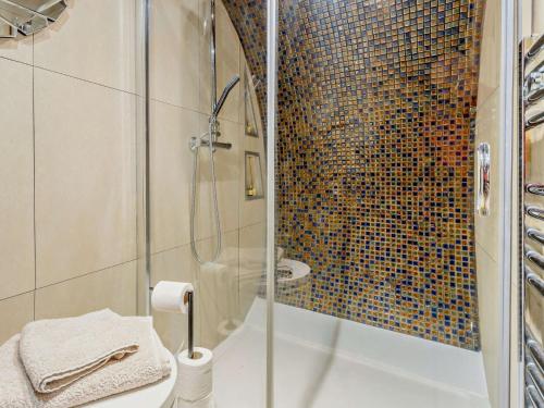a bathroom with a shower with a glass door at 1 Bed in Llanidloes 81415 in Van