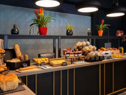 a buffet of bread and pastries on a table at ibis Cergy Pontoise Le Port in Cergy