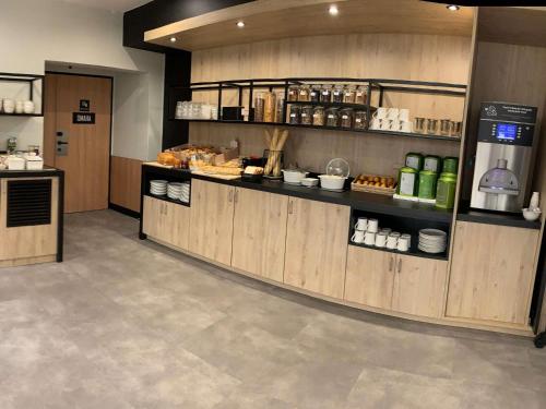 a kitchen with a counter with food on it at ibis Saint-Lô in Saint Lo