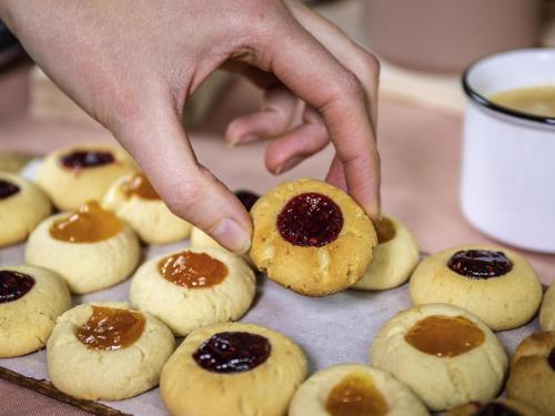 a person reaching for a cookie with jam on it at ibis Clermont Ferrand Montferrand in Clermont-Ferrand
