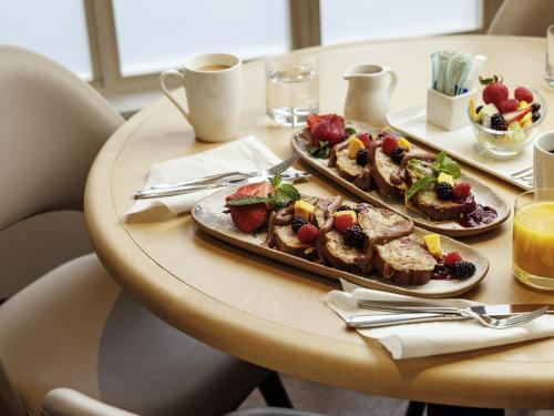 a table with two plates of food on it at The Novotel Toronto Centre in Toronto