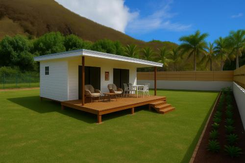 a house with a deck and a table and chairs at Moorea Tiki Lodge in Moorea