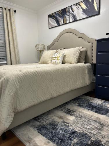 a bedroom with a bed and a blue dresser at Hibiscus Retreat fully equipped guest studio in Fayetteville