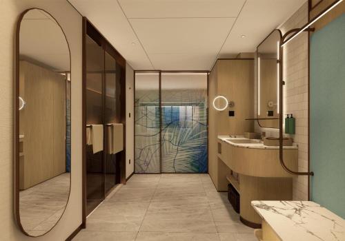 a bathroom with a mirror and a sink at Hilton Garden Inn Shenzhen Pingshan Chaoshang Plaza in Shenzhen