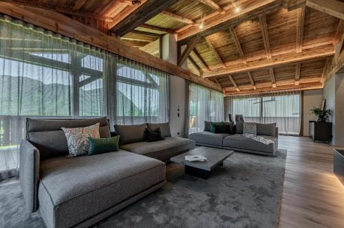 a large living room with a couch and a table at Chalet Pfarriweg Modern luxury in Sankt Anton am Arlberg