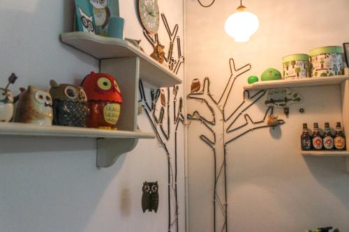 a room with a tree on a wall with shelves at Project Uchi SS2 in Petaling Jaya