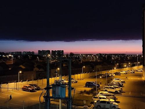 a parking lot filled with cars at night at Acogedor departamento sector Puertas del Mar in La Serena