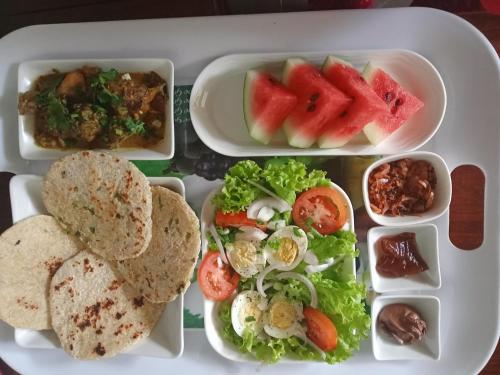 a tray with four trays of food on a plane at J's lodge in Negombo