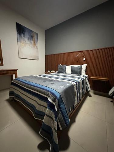 a bedroom with a bed with a blue blanket at Hotel Pastora in Córdoba