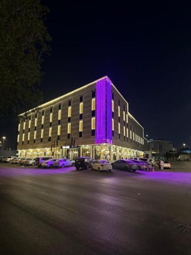 a large building with purple lighting in a parking lot at الجوهرة بارك 1 in Riyadh